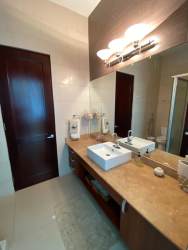 Elegant bathroom with glass shower enclosure and beige tiles Punta Barco Panama