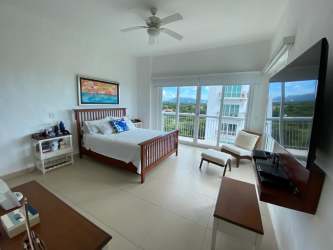 Contemporary bathroom with large mirror, granite countertop and wood vanity in Punta Barco Village Panama