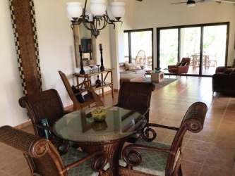 Contemporary bathroom with bathtub, wood vanity, large mirror and decorative tiles Altos del Maria villa Panama