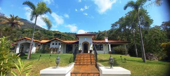 Spacious covered terrace with rustic beams, tiled floor and mountain views in Altos del Maria villa Panama