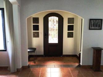 Modern rustic kitchen with granite countertops, exposed beams, ample cabinetry in mountain villa Altos del Maria Panama