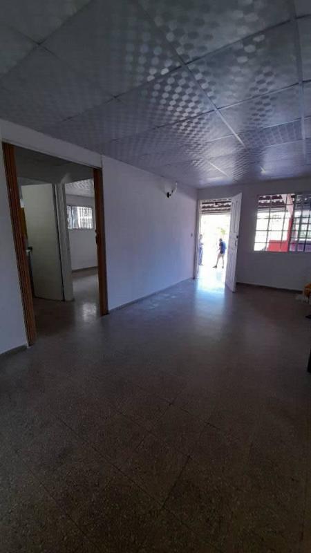 Open plan living-dining space with tiled floors and natural light in Panama house