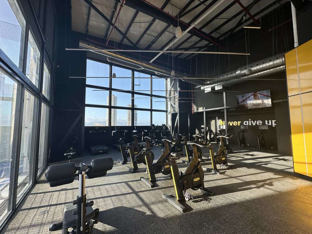 Modern equipped gym with panoramic windows in Ocean House Santa María Golf