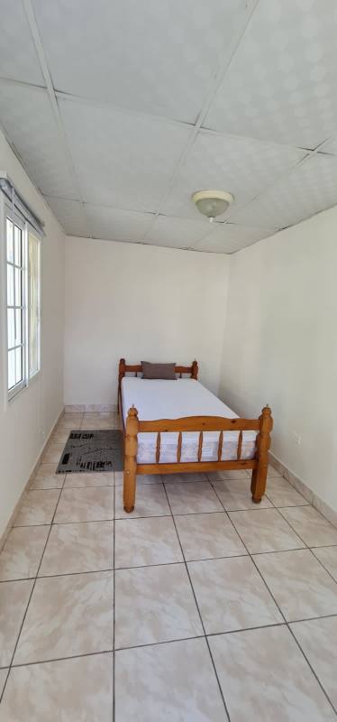Compact bathroom with pedestal sink, shower curtain, beige decor in Altavista Panama