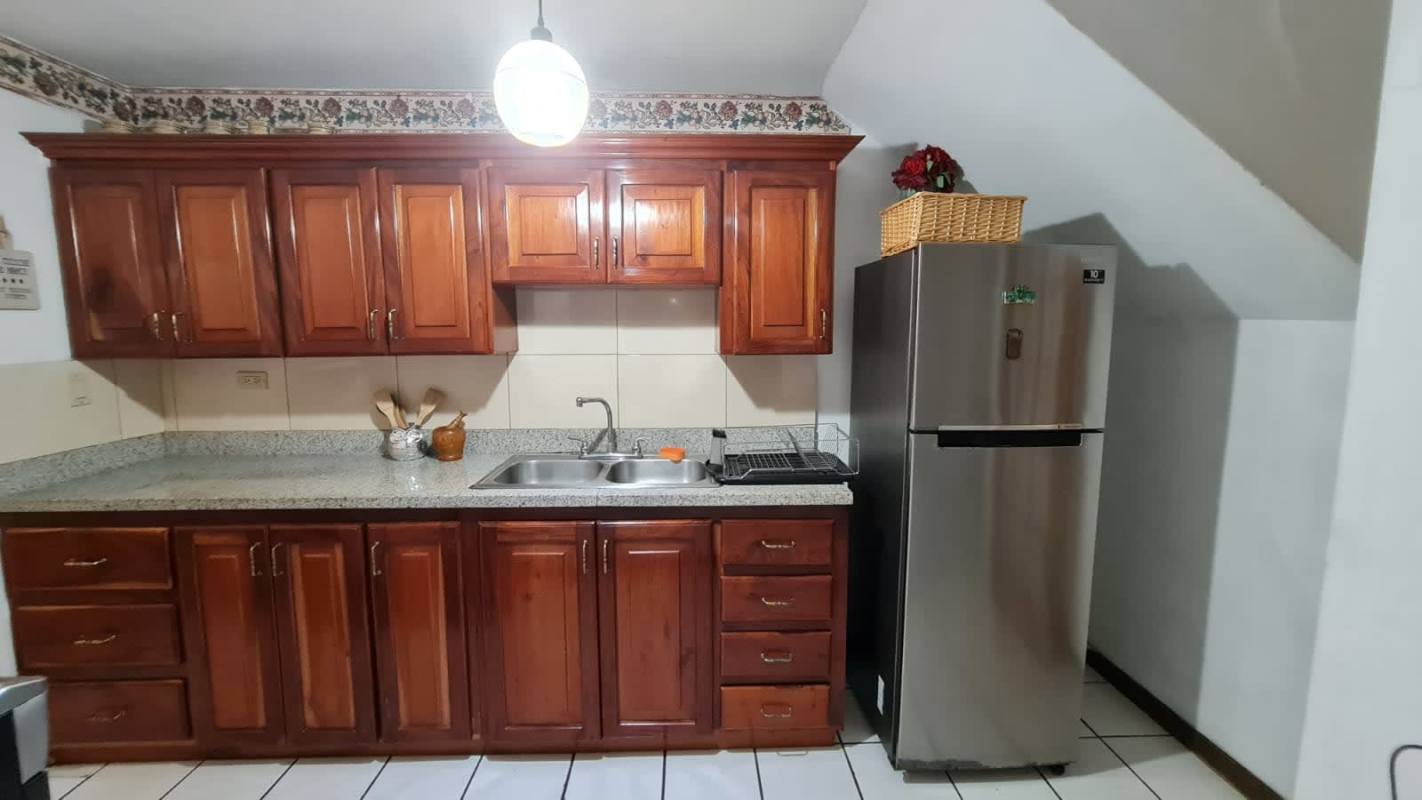 Minimalist bedroom with large window, AC, desk and wardrobe in furnished home for rent Panama