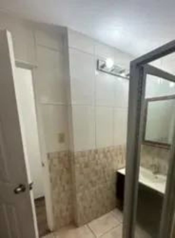 Modern bathroom featuring glass shower door, tile wall details, vanity mirror at PH Montserrat Obarrio