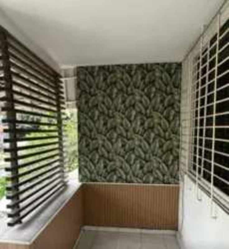 Balcony featuring leaf wallpaper and wood privacy screen overlooking Obarrio city view at PH Montserrat Panama