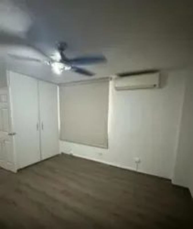 Spacious bedroom with ceiling fan, built-in wardrobe, window, wood floor in PH Montserrat Obarrio Panama City