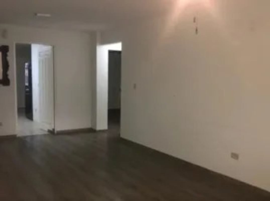 Open plan living/dining with wood floors and neutral walls in PH Montserrat Obarrio Panama City