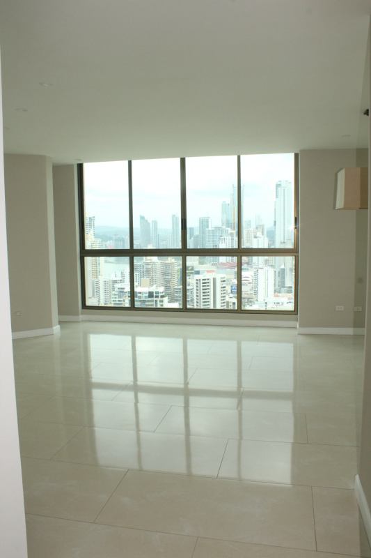 Spacious luxury penthouse living room with marble floors and floor-to-ceiling windows ocean and skyline views in PH Ocean Park Punta Pacifica Panama