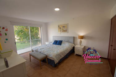 Bright bedroom with vaulted ceiling, balcony access, and garden views in Costa Blanca villa Panama