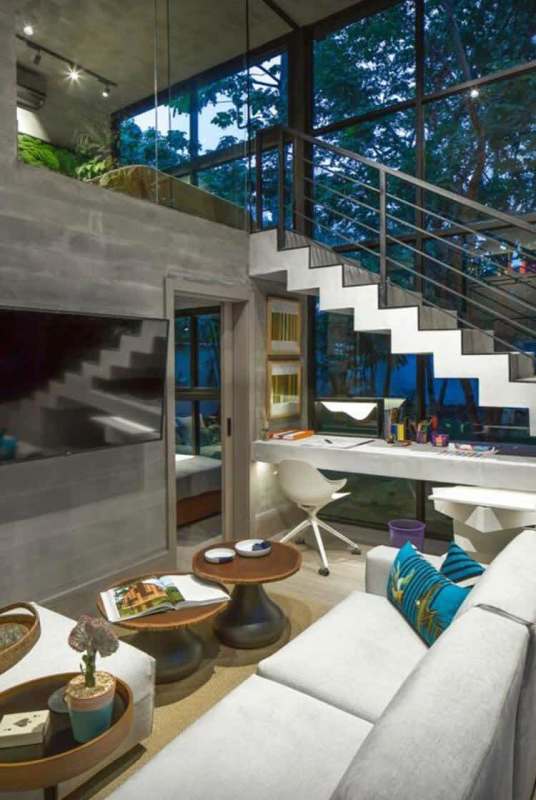 Bright double-height loft with work zone, concrete finishes, glass windows PH Dovle Coco del Mar