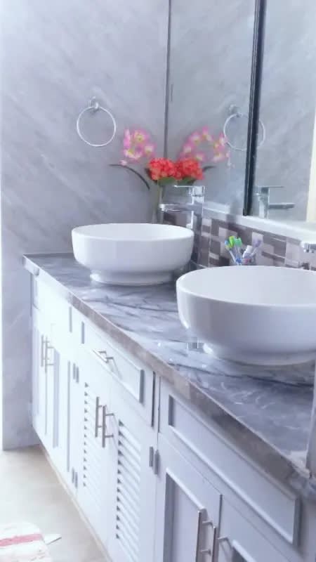 Modern kitchen with white cabinets, gas stove, refrigerator PH Elege Panama City