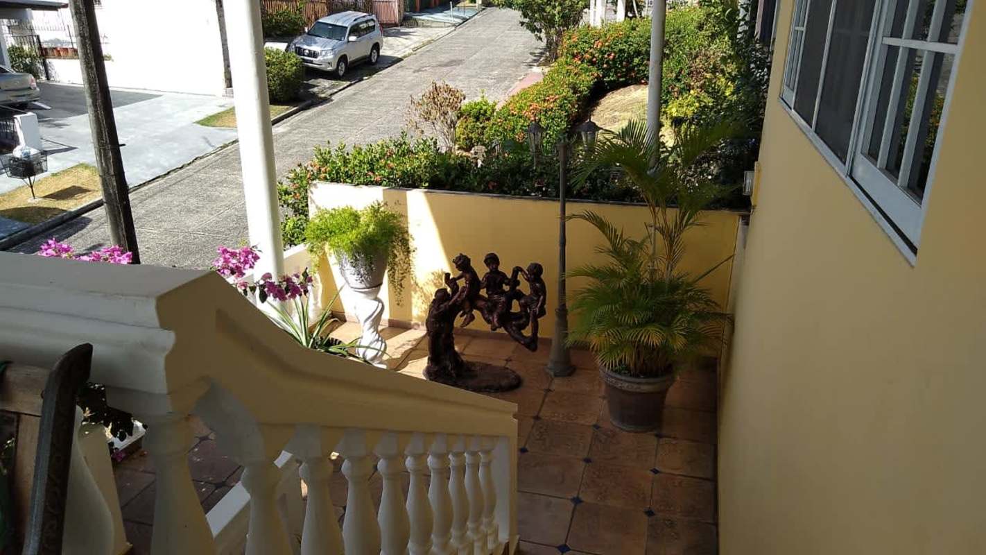 Front yard with staircase, planters, decorative sculpture and patio in Bethania Panama
