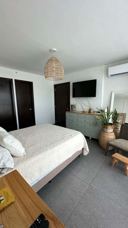 Modern kitchen area in PH Kings Park with open shelves wood cabinetry stone countertops in Condado del Rey Panama City