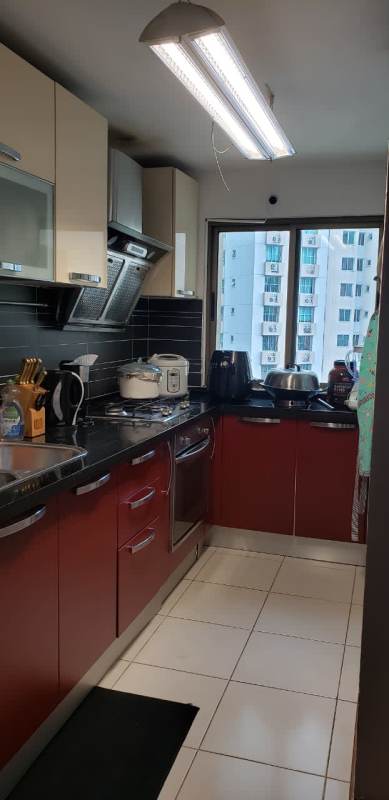 Contemporary kitchen with granite countertops and red cabinetry in Punta Pacifica apartment