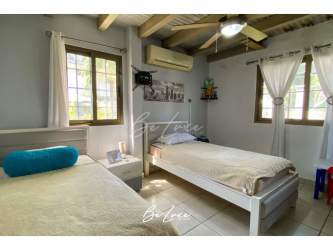 Covered BBQ bar terrace overlooking pool with outdoor seating at beach house Las Lajas Panama