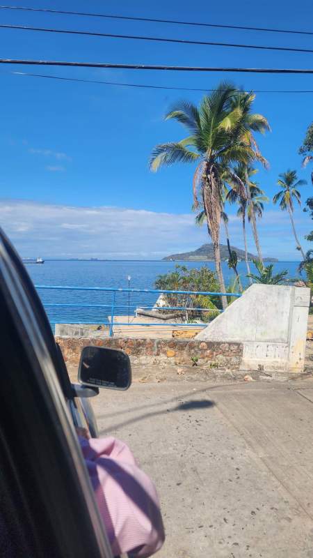 Tropical palms, blue ocean railing and island views seen from Taboga Panama land plots