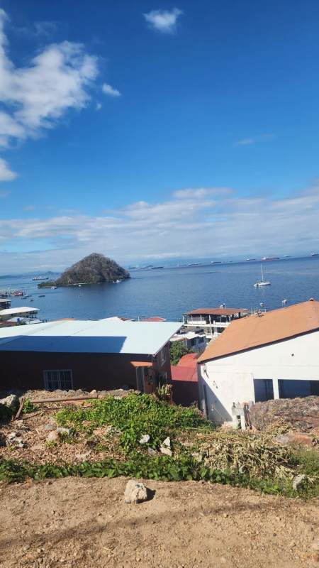 Coastal neighborhood with boats, waterfront homes and mountain backdrop Isla Taboga Panama