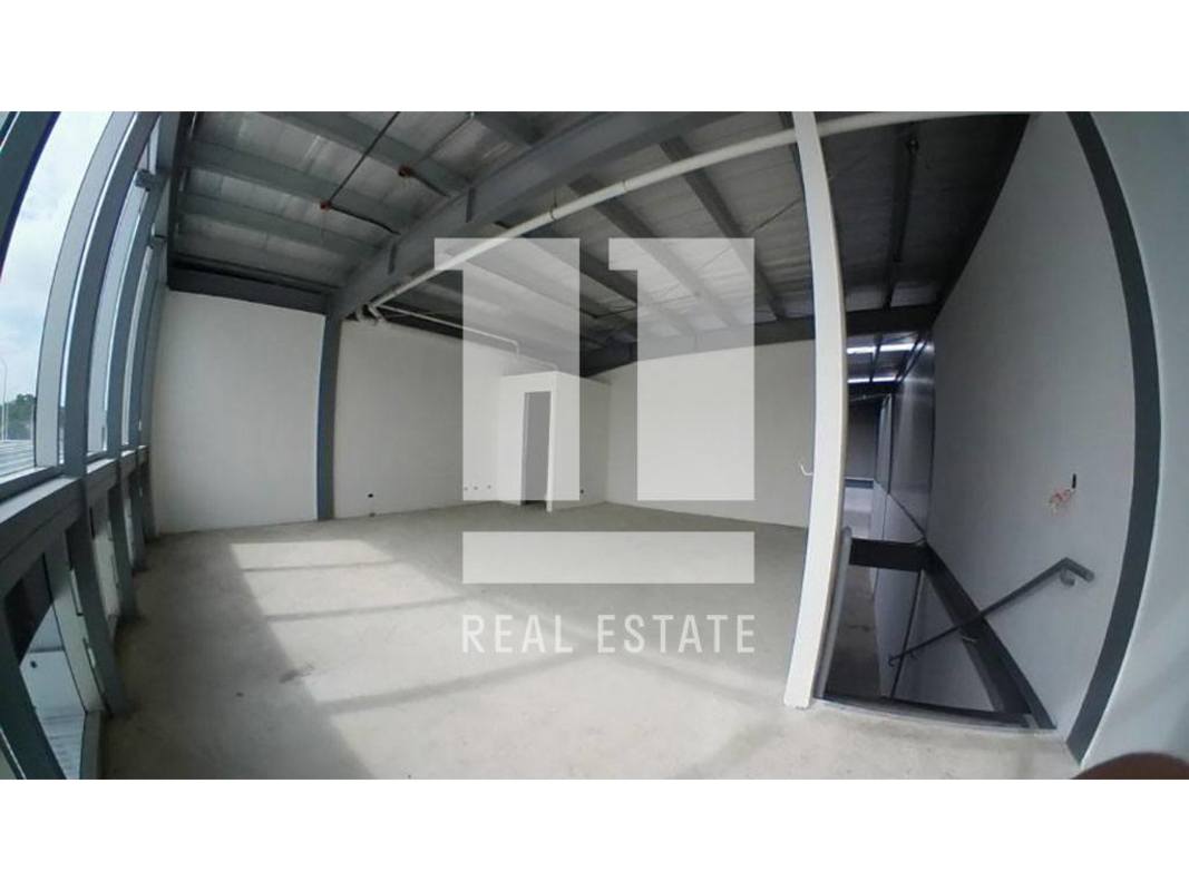 Second level mezzanine office space with glass wall overlooking warehouse floor in Panama Viejo Business Center