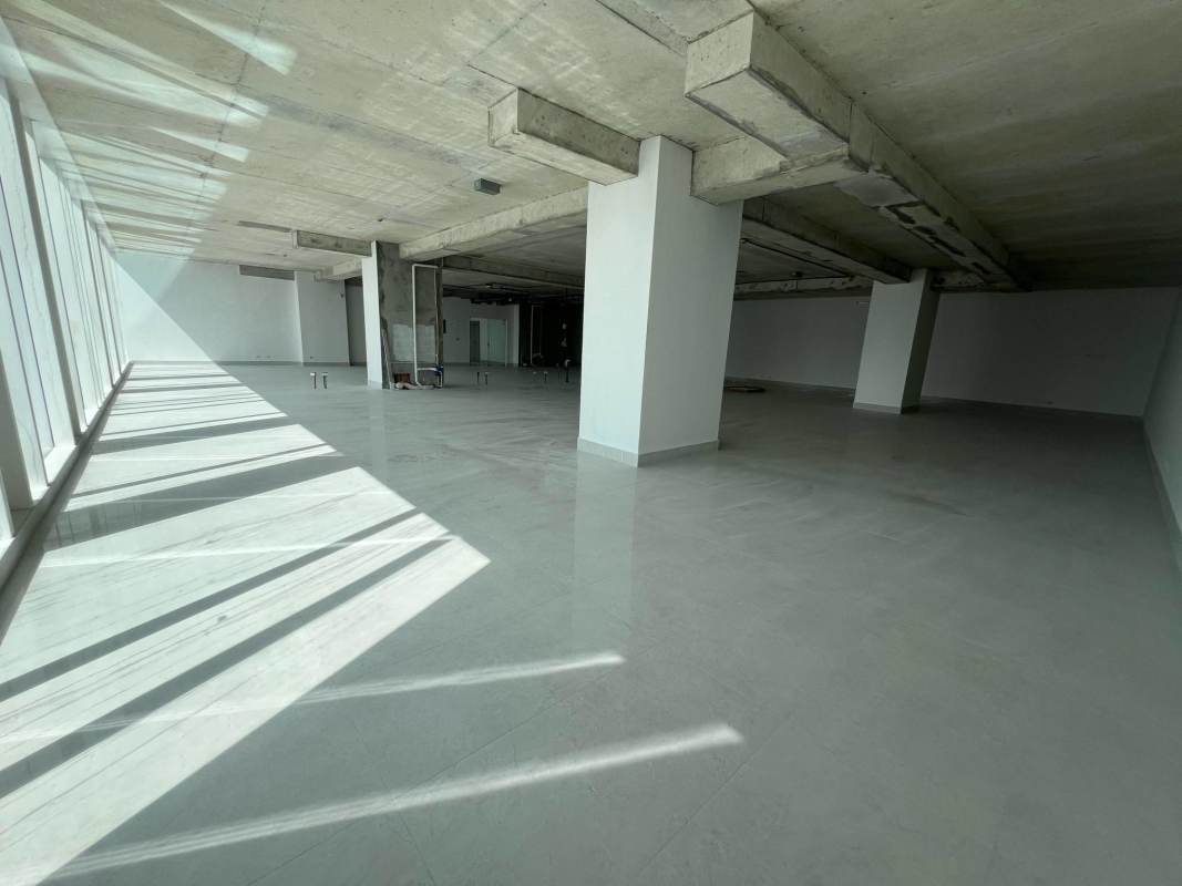 Unfinished commercial office shell with exposed concrete ceiling and large windows San Francisco Panama