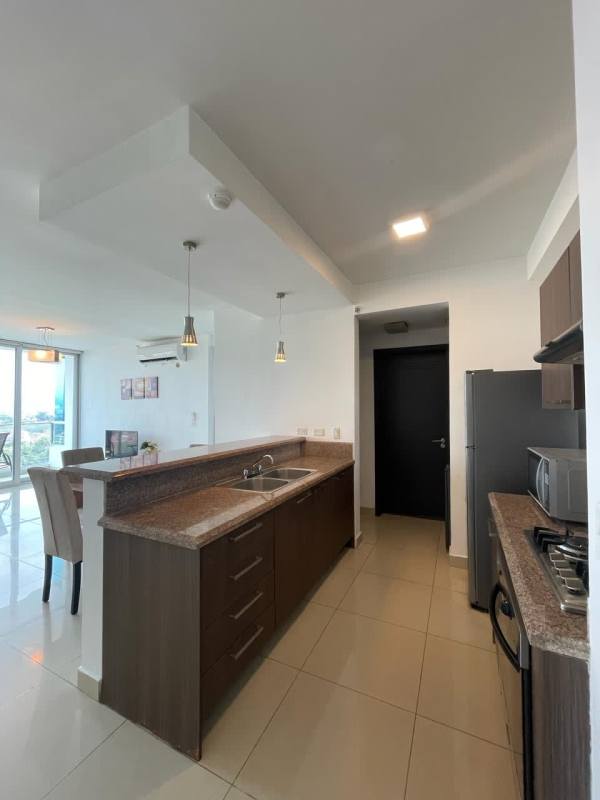 Fully equipped kitchen with granite counters and stainless appliances in PH Top Towers Costa del Este