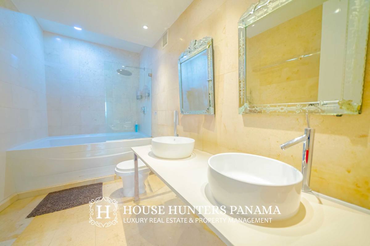 Elegant bedroom with floor-to-ceiling windows and ocean views at YOO Panama on Avenida Balboa