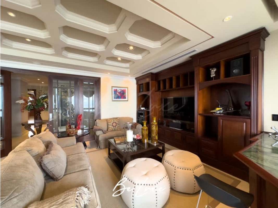 Modern gourmet kitchen with granite countertops, wood cabinets and stainless appliances in PH Panama Bay Tower penthouse Costa del Este Panama City