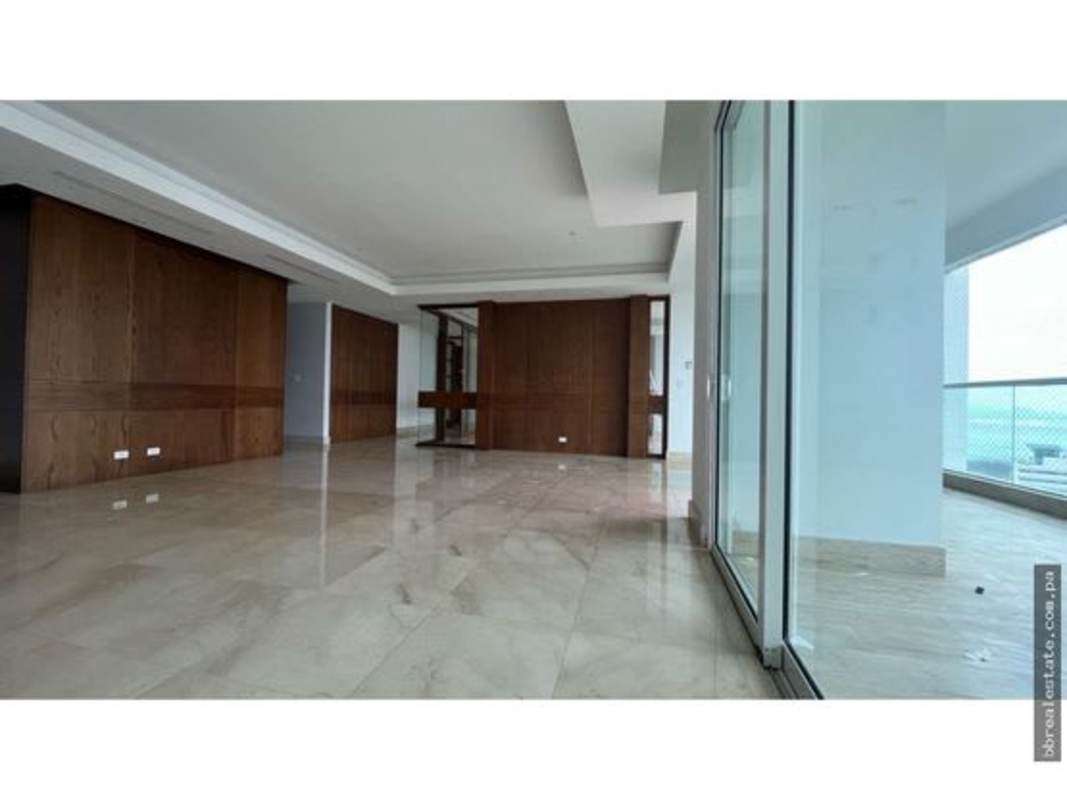 Large living space with marble floor, wood accent walls, balcony access in PH Aria Costa del Este