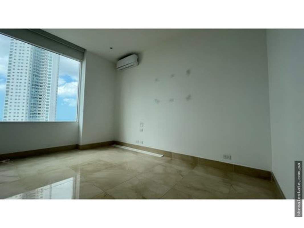 Spacious bedroom with panoramic windows, marble tile, city skyline view in PH Aria Panama City