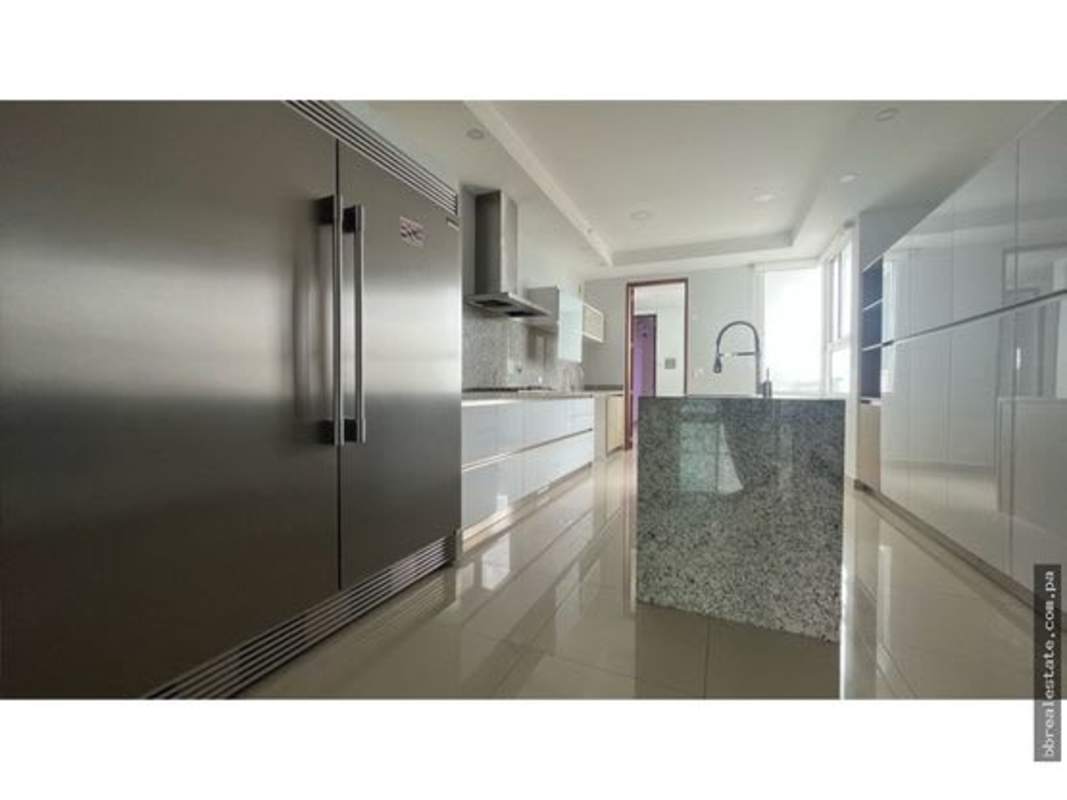 Spacious kitchen with granite island, stainless steel refrigerator, large windows in PH Aria Costa del Este