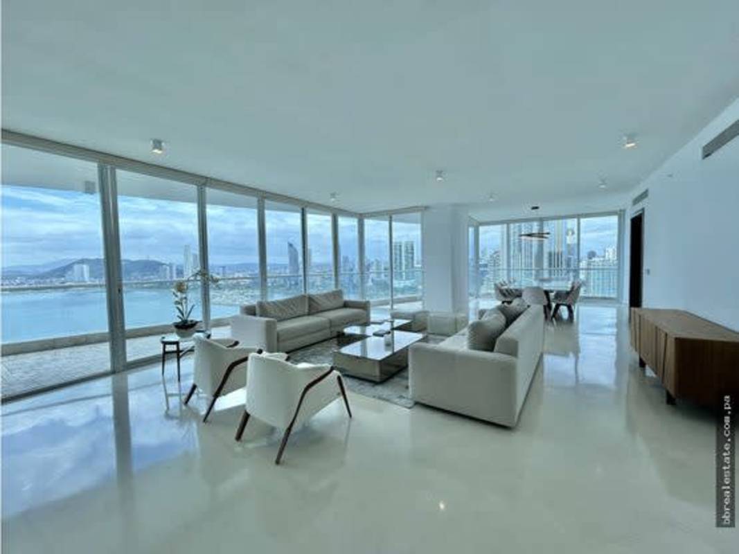 Elegant dining room with panoramic ocean and skyline views in luxury apartment at The Point Punta Paitilla