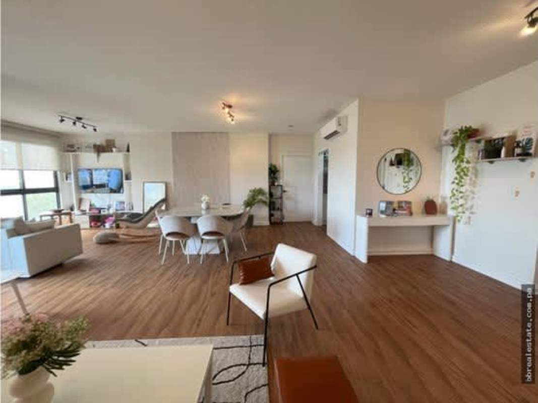Spacious open plan living and dining area with large windows, wood floors in PH Parque del Mar I Costa del Este Panama