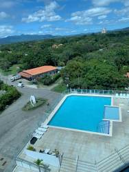 Aerial photo of large swimming pool surrounded by greenery at PH Ibiza Coronado Beachfront Panama