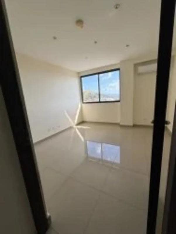 Bedroom with large window, AC installation area and tiled floor in PH Peake Point Panama