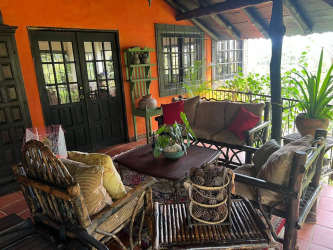 Country dining room with wood beams, large windows, brick walls in Las Lajas Sora Panama