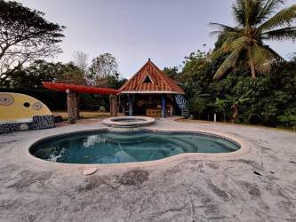 Rustic style kitchen with wood cabinetry and tile backsplash in Playa Coronado beach rental