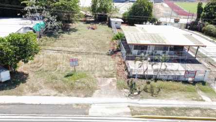 Flat commercial lot with street and sidewalk directly across mall in Chitre Panama