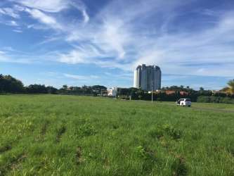 Flat lot close to beach surrounded by greenery in Sol y Mar gated community