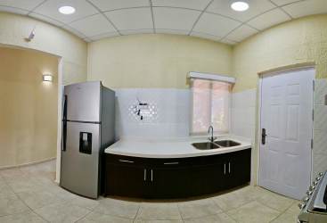 Resort-style outdoor pool with slide, sun loungers and palm trees in La Chorrera near Costa Verde