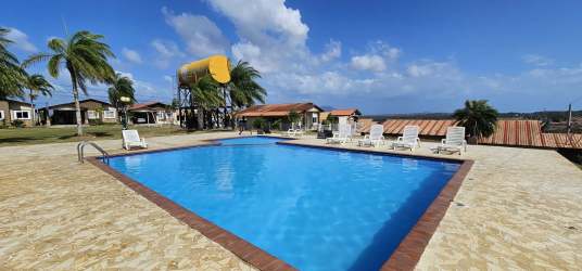 Outdoor playground with swings, slides, benches and green area in gated Panama neighborhood