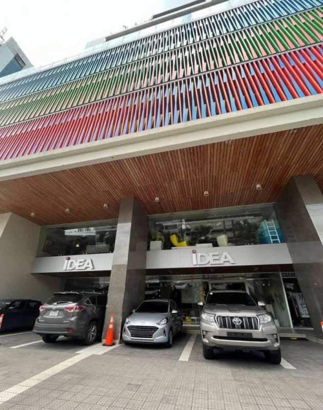 Multi-story commercial building with colorful louvers and parking in Obarrio Panama City