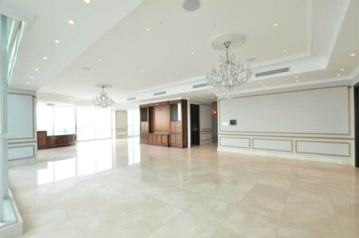 Open plan luxury living room with marble floors in penthouse Ocean Two Panama