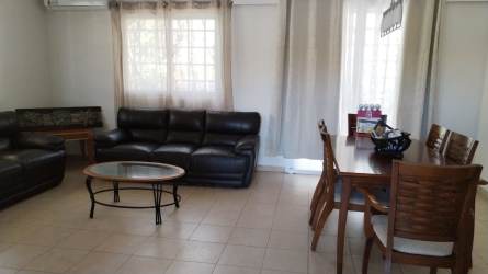 Bright living and dining space with sofas and dining table Las Villas Penonomé Panama