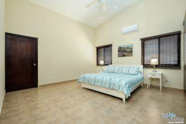 Bright living and dining room with vaulted ceilings and large windows in Coronado Golf house Panama