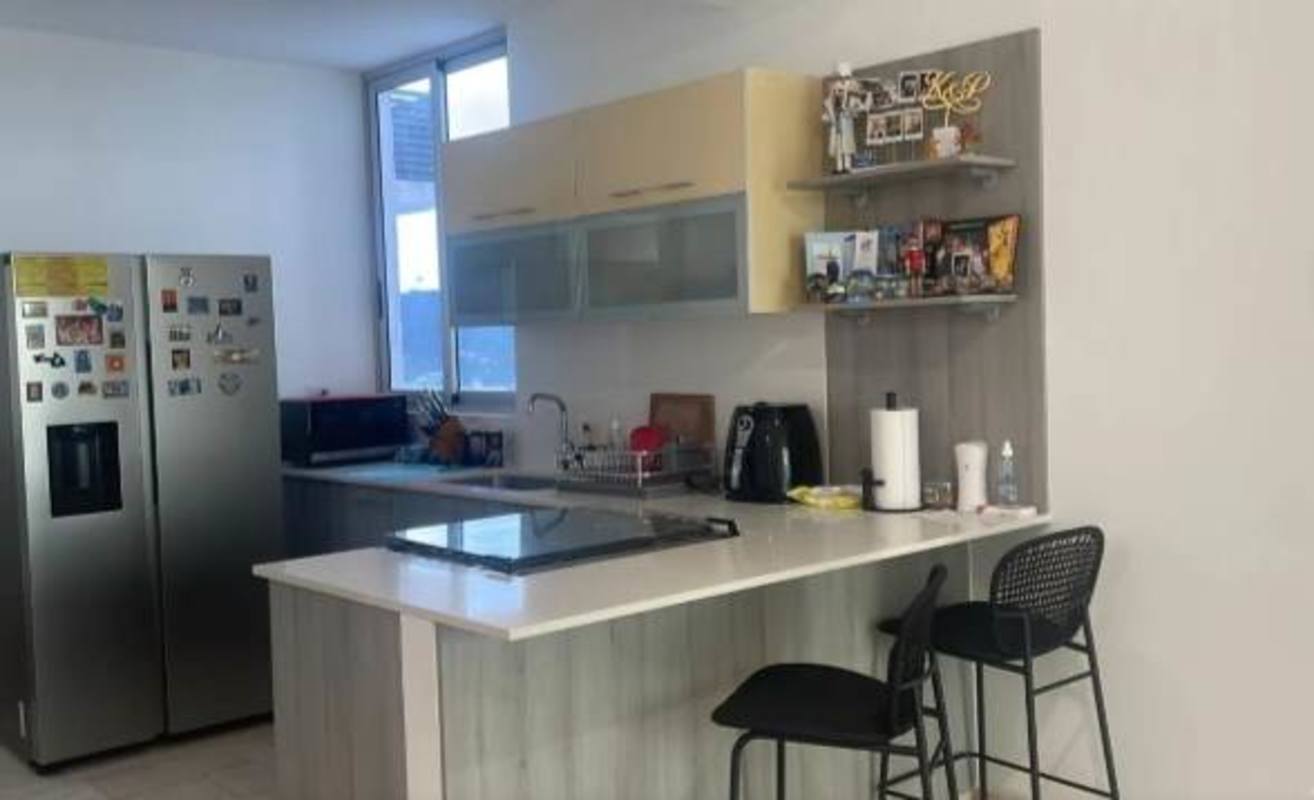 Contemporary kitchen with island, stainless appliances and large window PH Dynasty Residences Avenida Balboa Panama