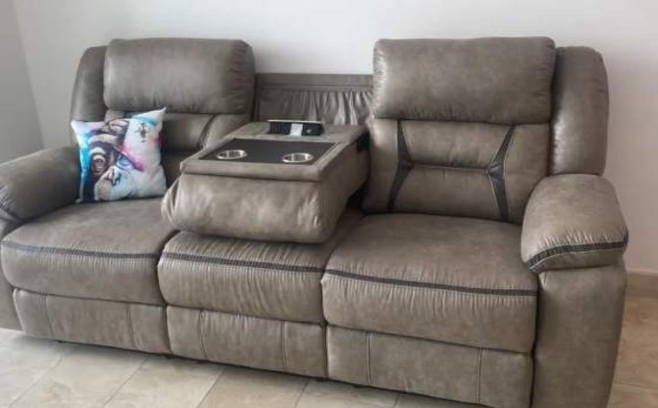 Comfortable gray reclining loveseat with cup holders colorful pillow Dynasty Residences Panama City
