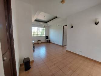 Spacious living room with large windows tiled floors and recessed ceiling at house in La Chorrera Panama