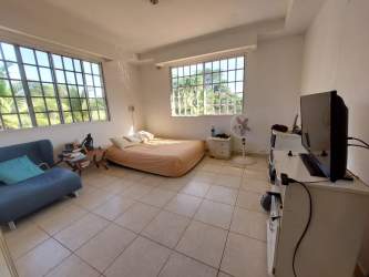 Bedroom with large window blue sofa tile floor in Guadalupe La Chorrera Panama
