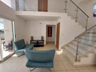 Open concept kitchen and dining area modern appliances at Playa Malibu luxury villa Panama